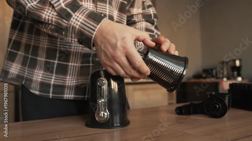 The hands of the householder assemble a manual vegetable slicer.
