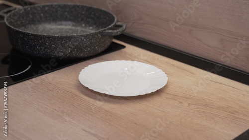 Peeled onions and carrots are placed on a white plate