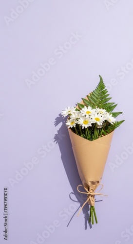 Bouquet of white flowers wrapped paper.