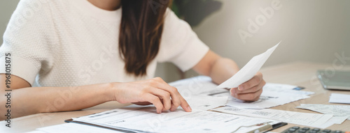 person using calculator calculating tax refund on the table