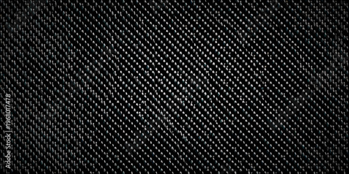 Close up of a dark textured fabric with a repeating diagonal pattern
