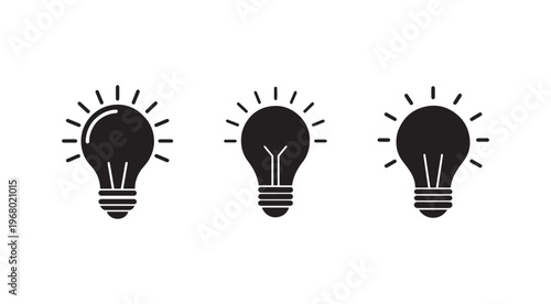 Three black light bulb icons with rays on white background  symbols of idea and inspiration