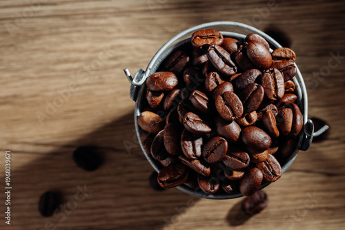 Freshly Roasted Coffee Beans in a Silver Bucket on Wooden Background