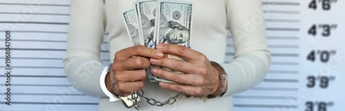 A woman holds money in front of a height chart, demonstrating the contrast between legality and illegality