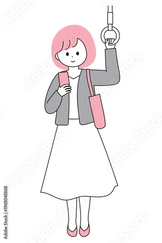 電車で通勤中にスマートフォンを見る若い上品な女性