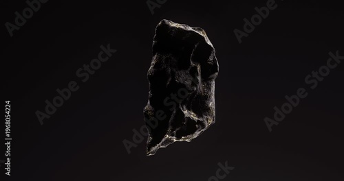 Single dark stone with golden veins floating in space highlighted by soft directional lighting.