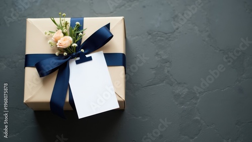 Elegantly wrapped gift box with floral accents and ribbon on a dark surface