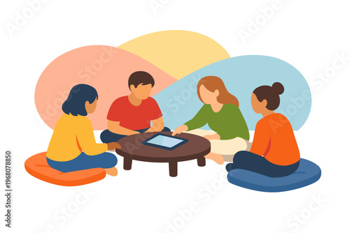 Four people sitting on cushions around a low table discussing a tablet device.