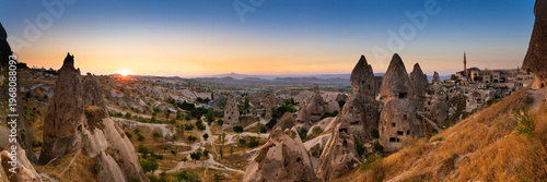 Fairy chimneys with the homes carved in stone. Panoramic view of a small valley near Uchisar castle in Cappadocia, Turkey.