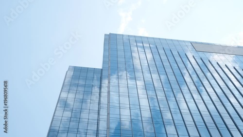 Modern business blue building against sky with clouds, time lapse.