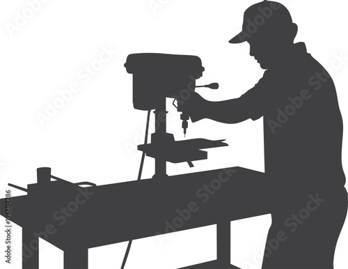 Silhouette of a man using a drill press