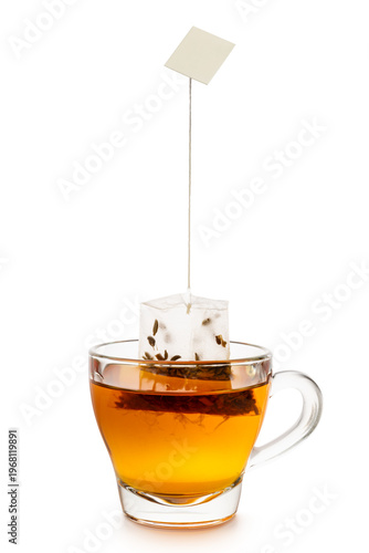 Glass cup of tea with tea bag inside, isolated on white background.