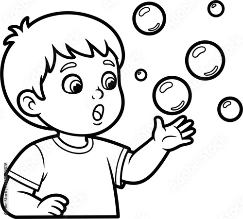 Boy playing with soap bubbles outside.