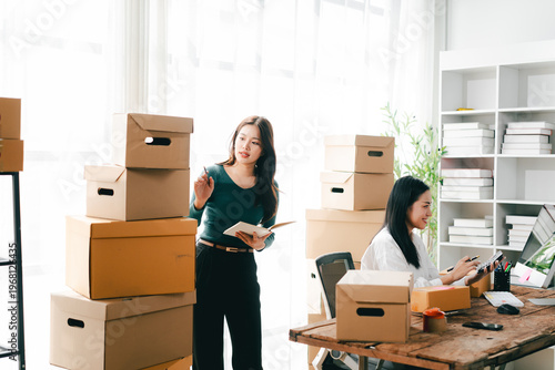 Small and medium-sized enterprise (SME) business owners are checking inventory, packing goods, and preparing for shipment.