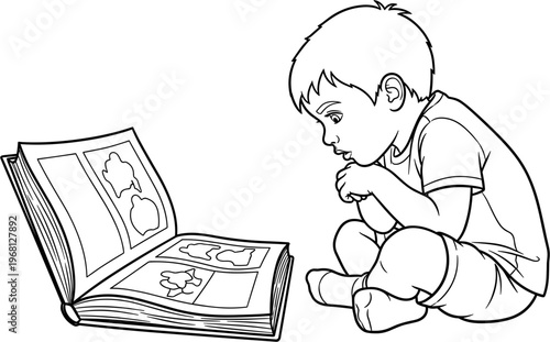 young boy reading a book.