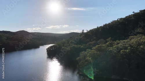 Drone across lake sun on water