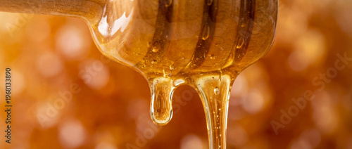 The flowing texture of liquid golden honey is perfect for food design backgrounds or natural concepts.