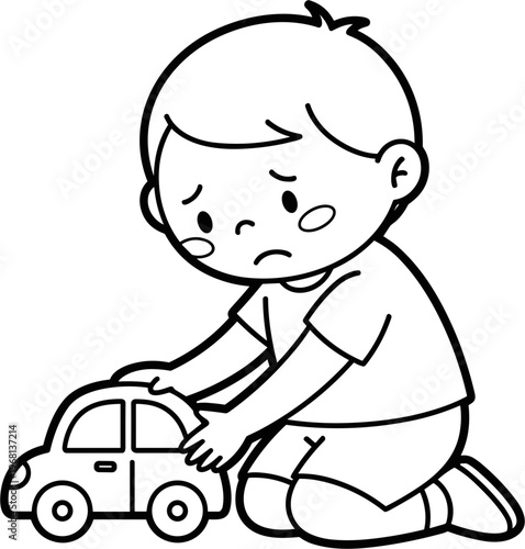 Sad child playing with toy car.