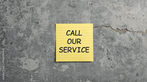 Call Our Service Concept With Yellow Sticky Note On Grey Concrete Wall For Customer Support Business