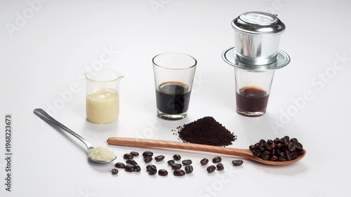 Professional wide shot of a full Vietnamese coffee combo: sugar, roasted beans, ground coffee, milk, and phin filter on a white background. Complete recipe concept.