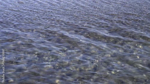 Crystal clear river water flowing over a gravel bed in Japan