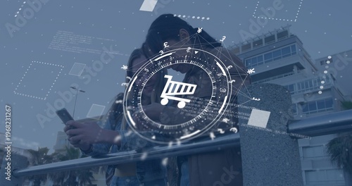 Viewing smartphone, two teens in denim jackets leaning over railing at waterfront, with HUD overlay