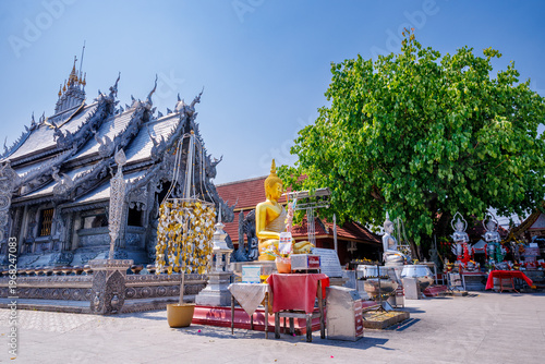 The stunning Silver Shrines or Wat Sri Suphan, a famous silver chapel decorated with traditional Lanna intricate carvings under a bright sunny sky in Chiang Mai, Thailand.