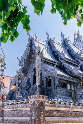 The stunning Silver Shrines or Wat Sri Suphan, a famous silver chapel decorated with traditional Lanna intricate carvings under a bright sunny sky in Chiang Mai, Thailand.