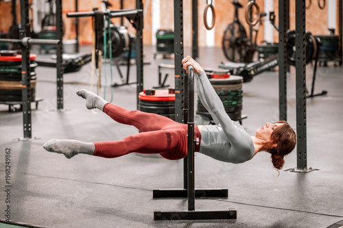 Wallpaper Mural Woman performing straddle front lever calisthenics exercise Torontodigital.ca