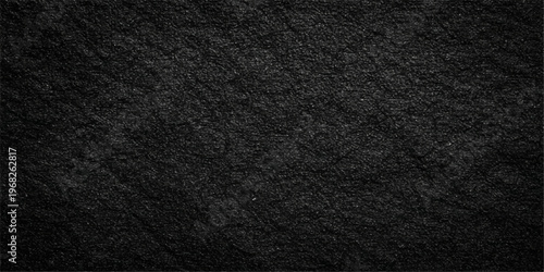 A dark textured background featuring a macro pattern of rough black leather and old fabric material for a seamless clothing textile surface wallpaper design