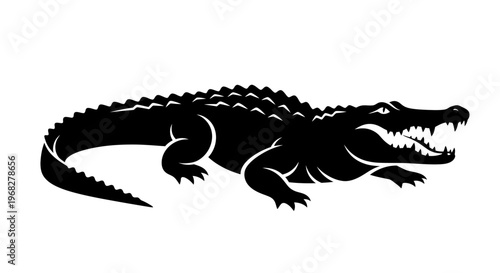 Black silhouette of a powerful alligator with open jaws.