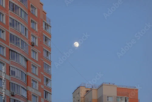 The moon in the sky above the houses