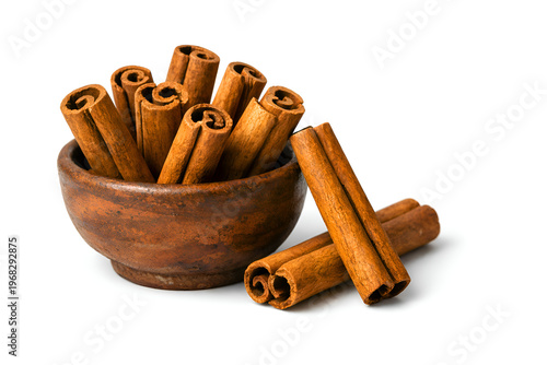 Premium Cinnamon Sticks in Rustic Clay Bowl Isolated on White