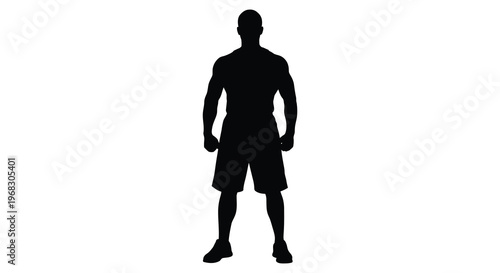 Muscular man standing in a striking pose a dark silhouette