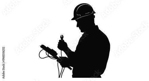 Construction worker inspecting electrical wiring a dramatic silhouette