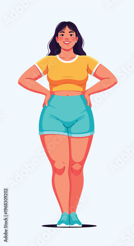 A smiling plus-size woman with dark hair standing in a yellow top and blue shorts
