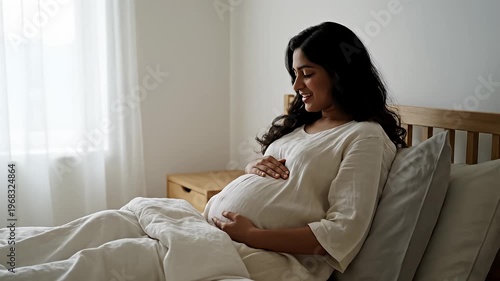 Wallpaper Mural Pregnant Indian woman relaxing in bed looking out window Torontodigital.ca