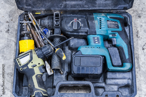 Fotografie Cordless electric drills and accessories in an open tool kit, ready for DIY construction and repair work