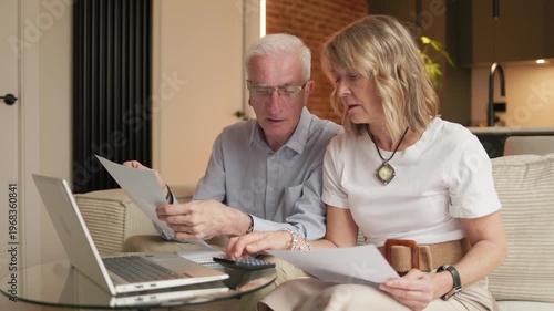 Senior couple calculating retirement pension budget financials at home