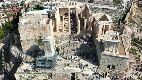 Aerial drone cinematic still video of iconic Propylea or gate of Acropolis hill and the Parthenon, Athens historic centre, Attica, Greece