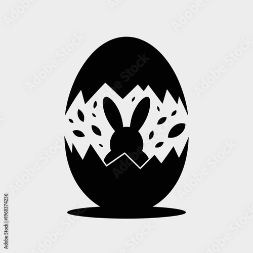 A minimalist vector graphic of a bunny emerging from a cracked Easter egg in black and white