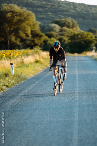 Photos Solo Male Cyclist Moving Forward On Peaceful Country Road Decorated With Bloomin