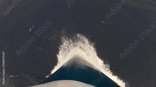 Top view of the bow of a cruise ship slicing through the ocean's surface