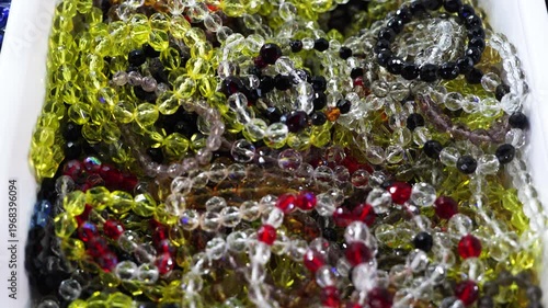 Colorful transparent glass bead bracelets arranged in decorative composition