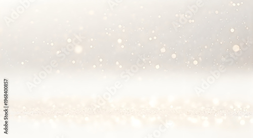 Soft golden bokeh lights and glitter particles shimmering on a bright white surface for a festive background isolated on white background
