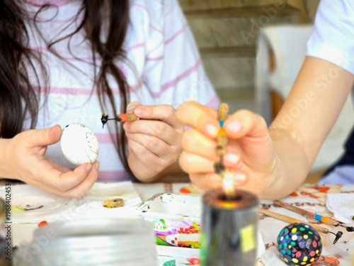 Child draws paints. The color of eggs for Easter.