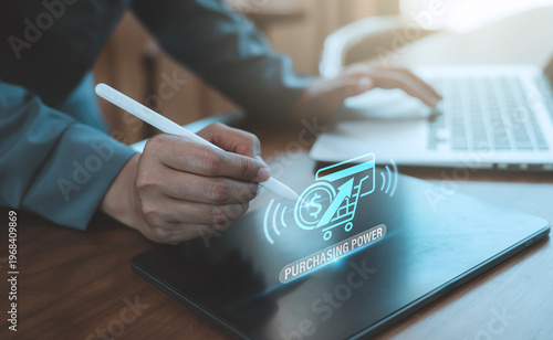 Quadro su tela Real purchasing power concept showing a person using a stylus on a tablet with a