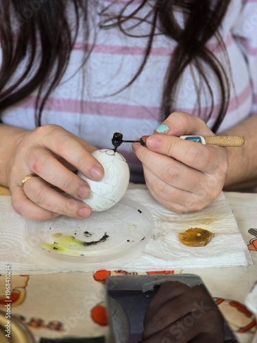 Сlose up of a young woman preparing a salad. The color of eggs for Easter.