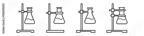 Laboratory glassware setup with Erlenmeyer flasks on stands for experiments