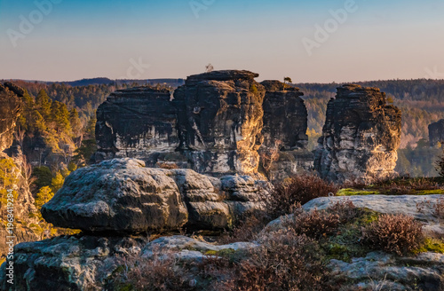 Beautiful view of the towering Bastei rock formations rising above the Germany’s Saxon Switzerland National Park in January during sunrise.